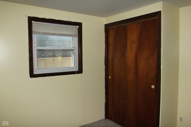 unfurnished bedroom featuring carpet and a closet