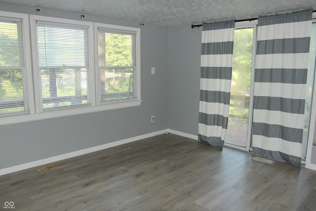 unfurnished room featuring dark hardwood / wood-style flooring