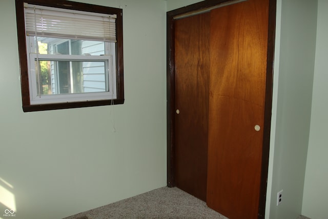 unfurnished bedroom featuring carpet and a closet