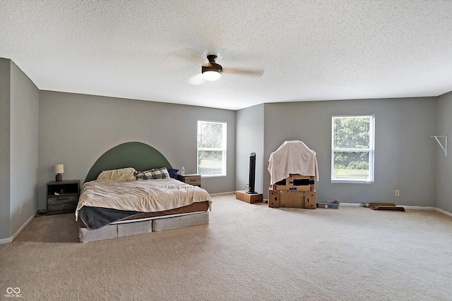 carpeted bedroom with a textured ceiling and ceiling fan