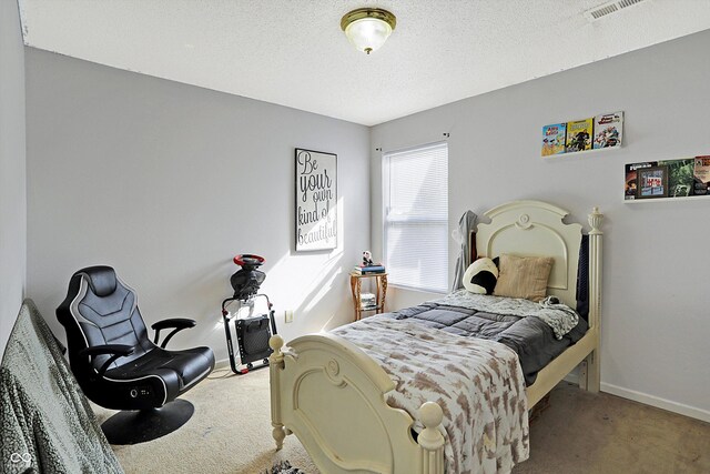 bedroom featuring carpet flooring and a textured ceiling