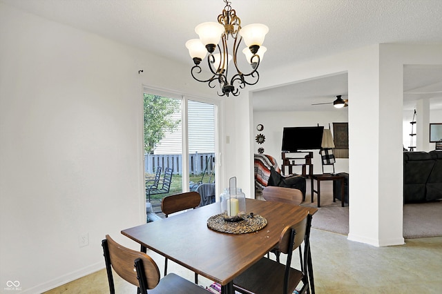 dining room featuring a textured ceiling and ceiling fan with notable chandelier