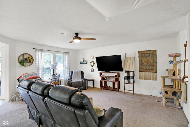 living room featuring a textured ceiling, ceiling fan, and light carpet