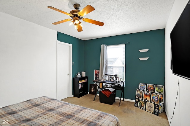 carpeted bedroom with ceiling fan and a textured ceiling