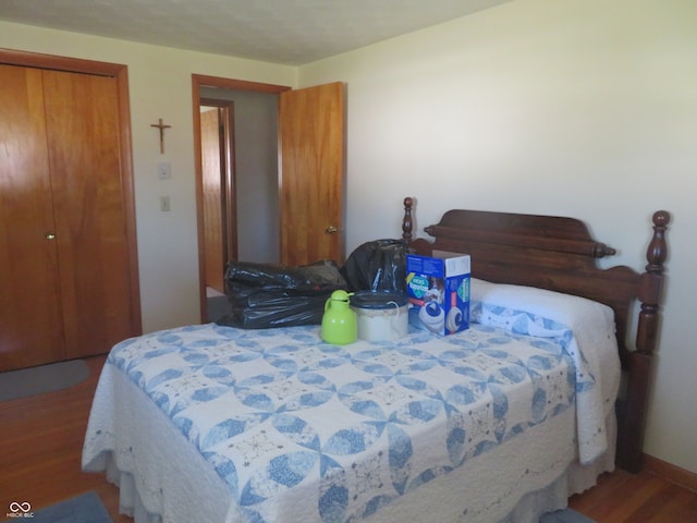 bedroom with hardwood / wood-style flooring and a closet