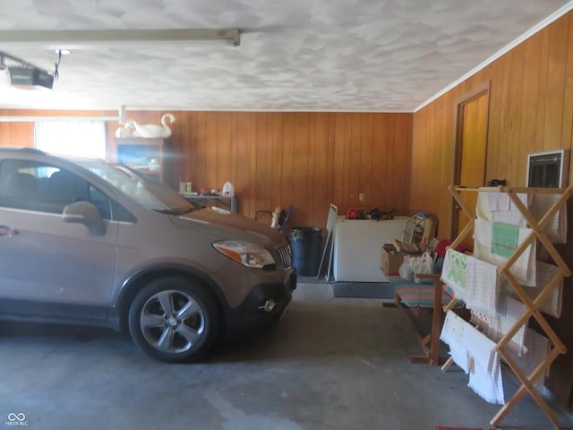 garage with a garage door opener and wood walls