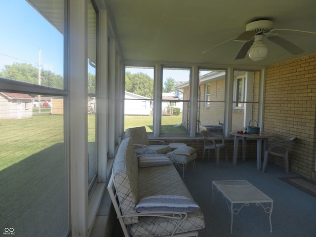 sunroom / solarium featuring ceiling fan