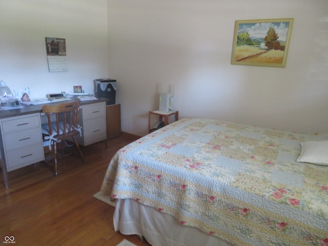 bedroom with dark hardwood / wood-style floors