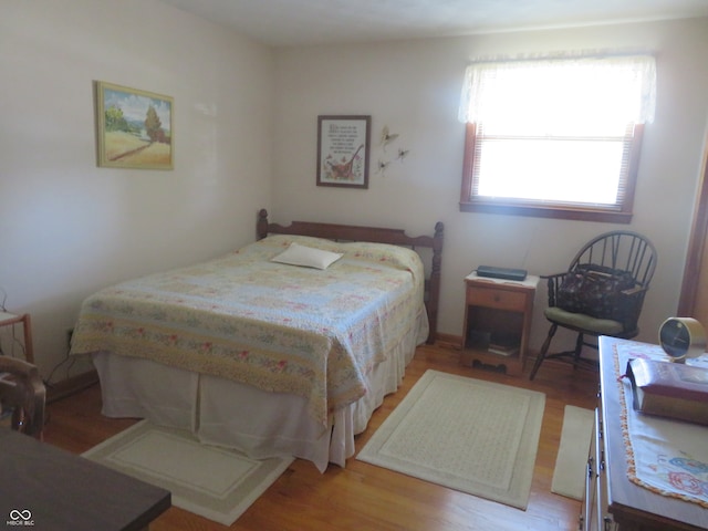 bedroom with hardwood / wood-style flooring