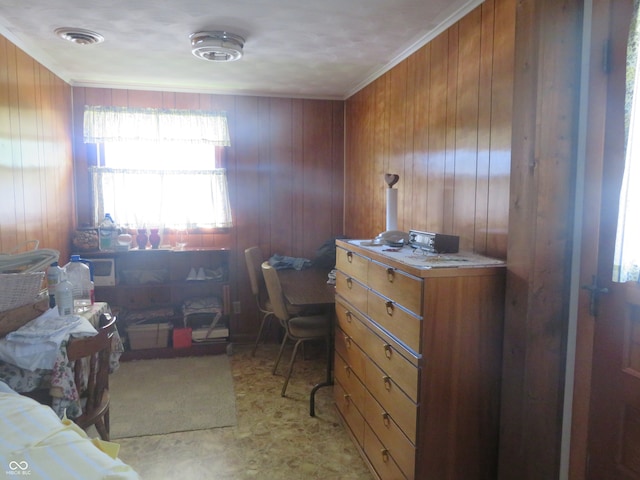 home office with crown molding and wood walls