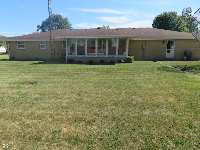 rear view of property with a yard