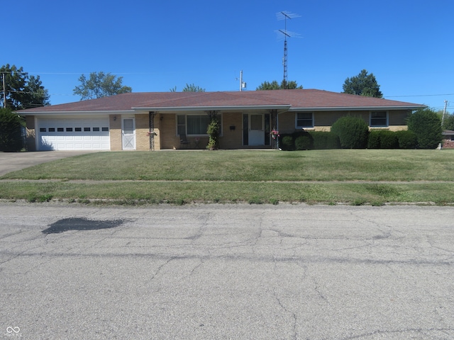 ranch-style house with a garage and a front lawn