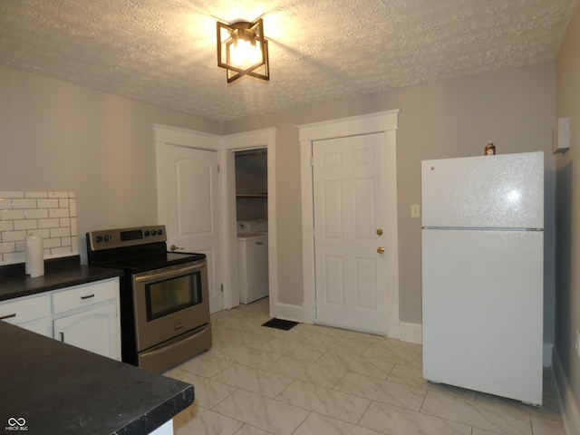 kitchen with a textured ceiling, white cabinetry, stainless steel range with electric cooktop, and white fridge