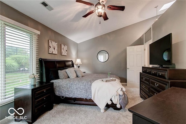 bedroom with light colored carpet, vaulted ceiling, and ceiling fan