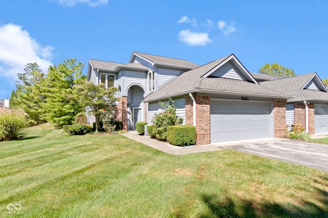 view of front facade with a front yard and a garage