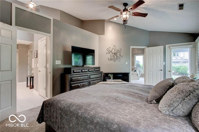 bedroom with ceiling fan, light tile patterned floors, and vaulted ceiling