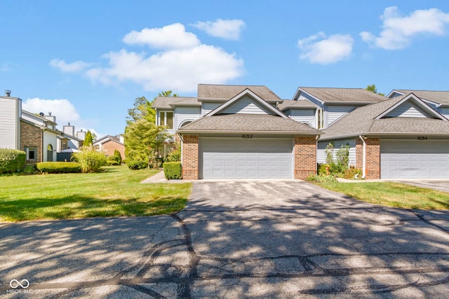 view of front of house featuring a front yard and a garage