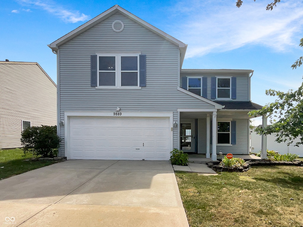 view of front facade featuring a front lawn and a garage