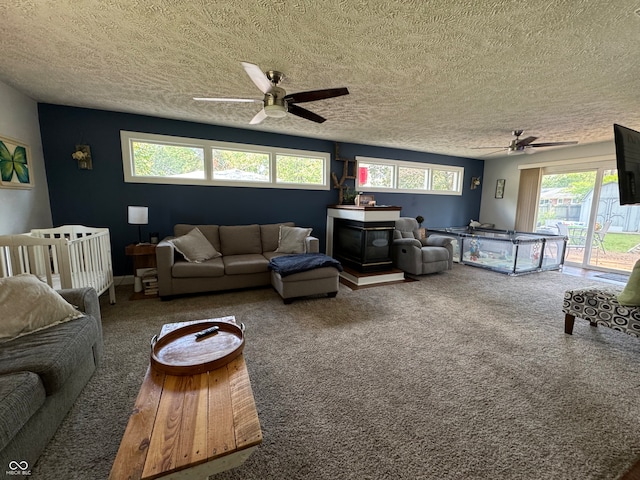 carpeted living room with a textured ceiling and ceiling fan