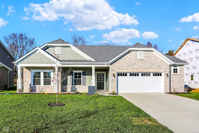 craftsman inspired home with a front yard and a garage