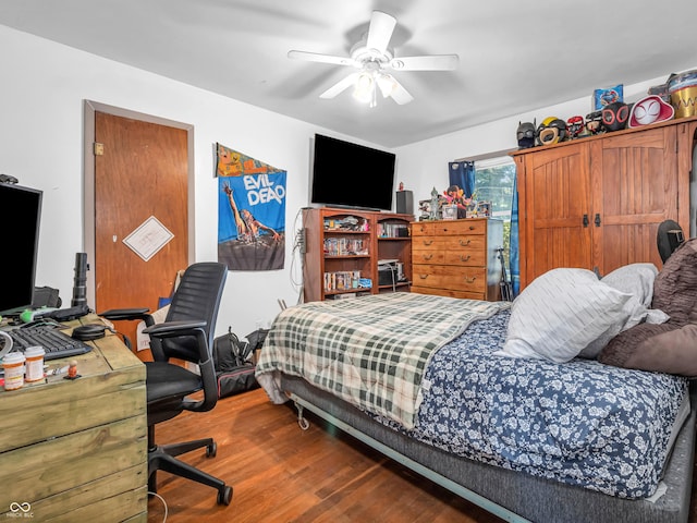 bedroom featuring a ceiling fan and wood finished floors