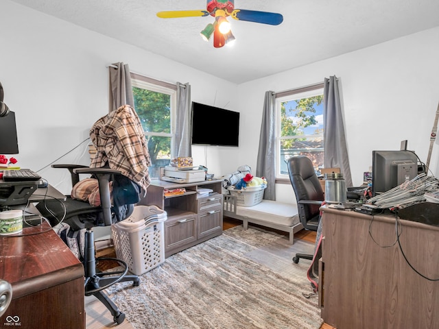 office space with wood finished floors and ceiling fan