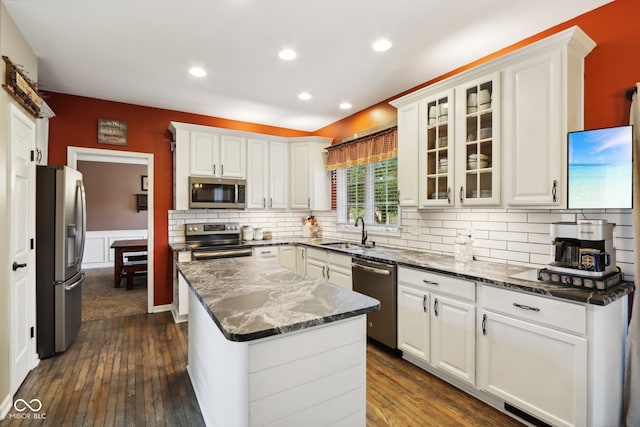 kitchen featuring stainless steel appliances, dark hardwood / wood-style flooring, white cabinetry, and sink