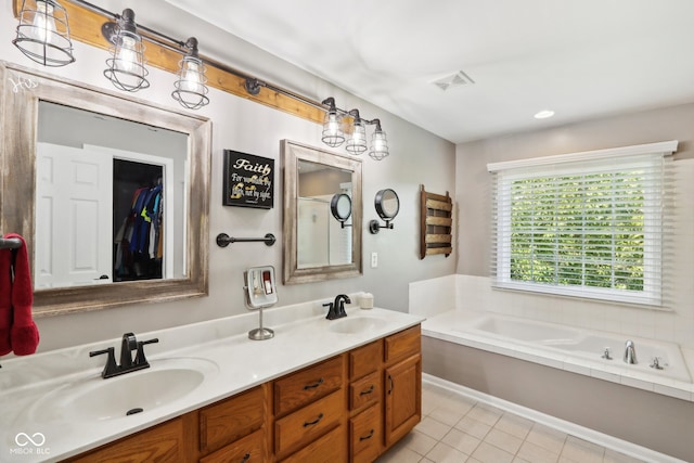 bathroom featuring vanity, a tub, and tile patterned floors