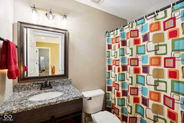 bathroom featuring a shower with curtain, toilet, and vanity