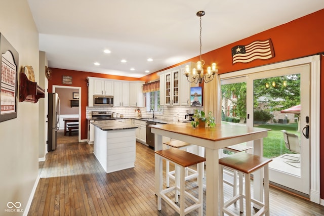 kitchen featuring white cabinets, appliances with stainless steel finishes, and dark hardwood / wood-style floors