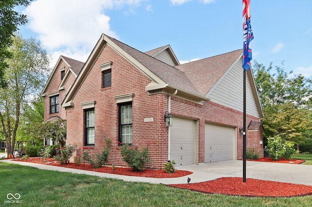 view of property with a garage and a front lawn