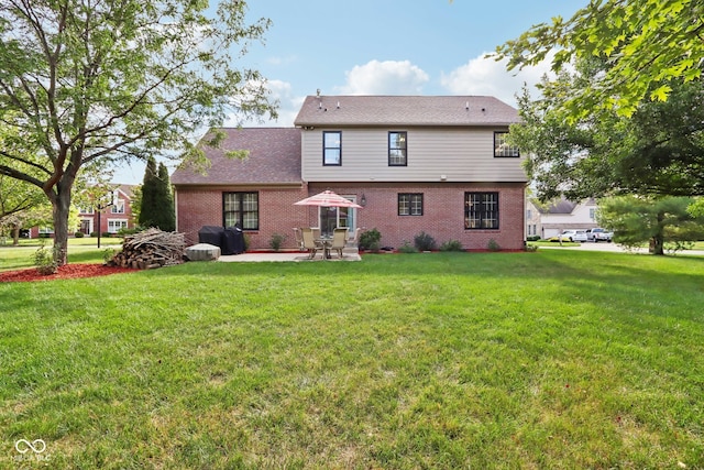 back of house featuring a lawn and a patio area