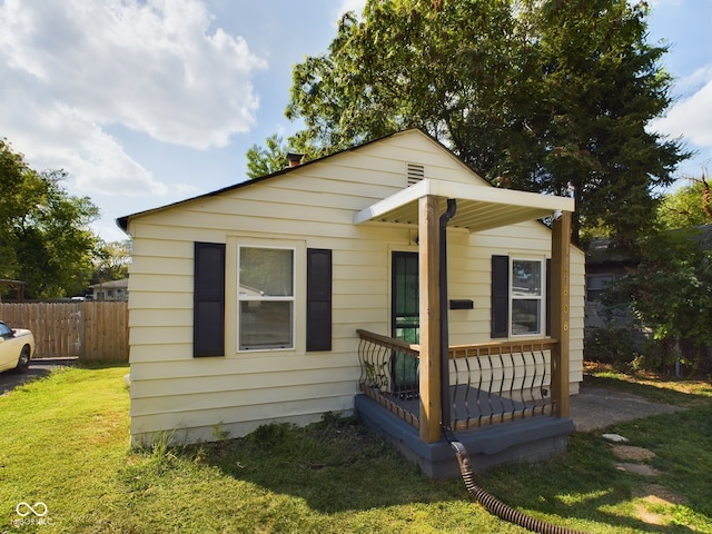 bungalow-style home featuring a porch and a front lawn