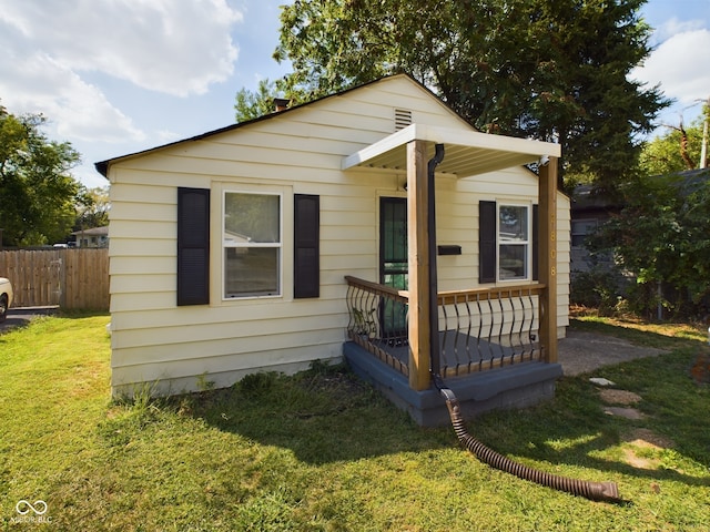 bungalow-style home with a front yard