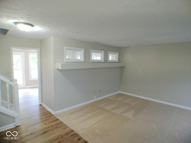 empty room featuring hardwood / wood-style floors and a textured ceiling