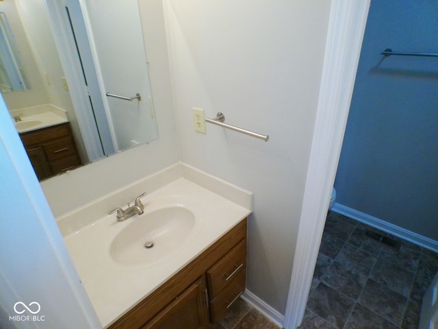 bathroom featuring vanity and toilet