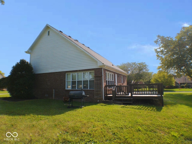 view of side of home with a yard and a deck