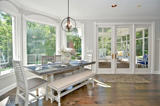 sunroom featuring a wealth of natural light and an inviting chandelier