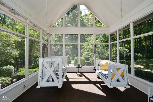 sunroom / solarium featuring lofted ceiling