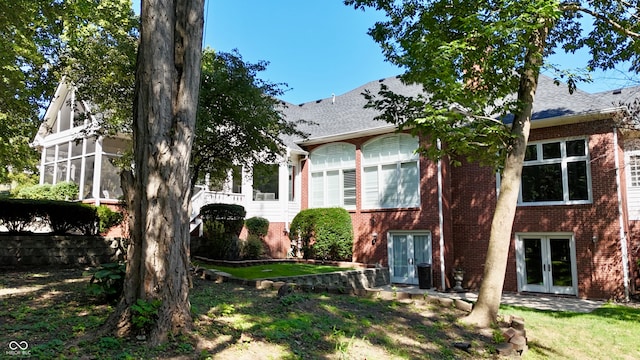 view of front of property with a front lawn and french doors