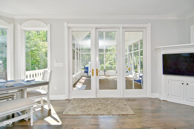 entryway with ornamental molding, dark hardwood / wood-style floors, and french doors