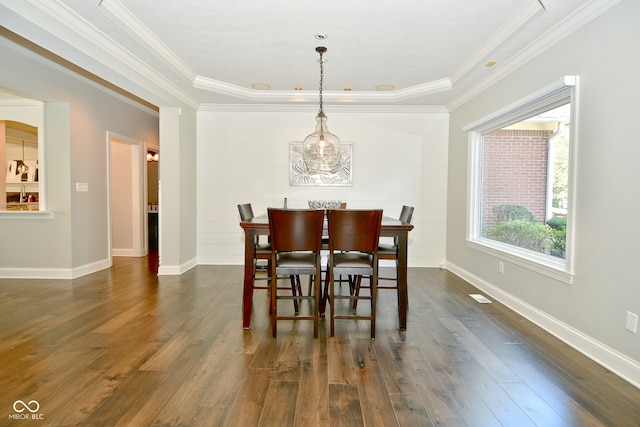 dining area with dark hardwood / wood-style flooring and ornamental molding