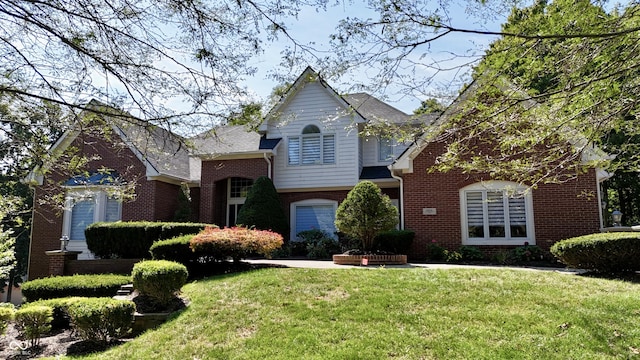 view of front facade featuring a front yard and brick siding