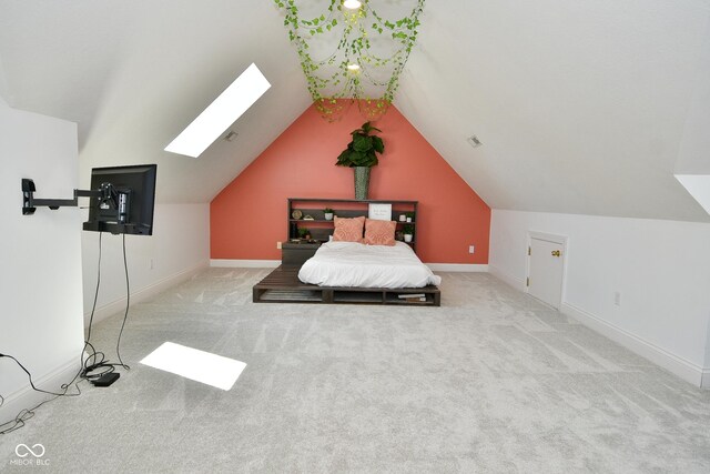 unfurnished bedroom featuring vaulted ceiling with skylight and carpet