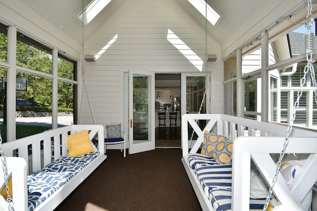 sunroom / solarium with vaulted ceiling with skylight