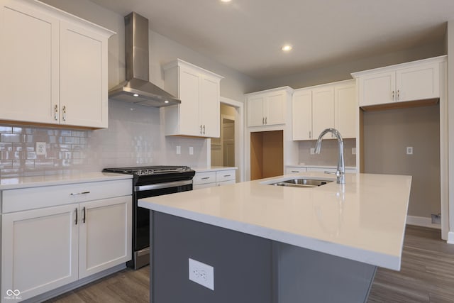 kitchen with dark hardwood / wood-style flooring, a center island with sink, stainless steel range with electric cooktop, and wall chimney range hood