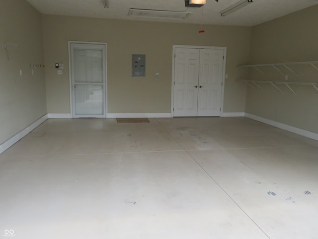 garage featuring a garage door opener and electric panel