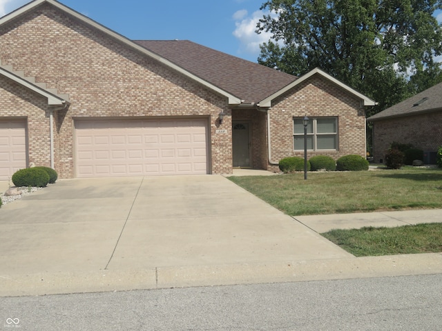 ranch-style house with a front yard and a garage