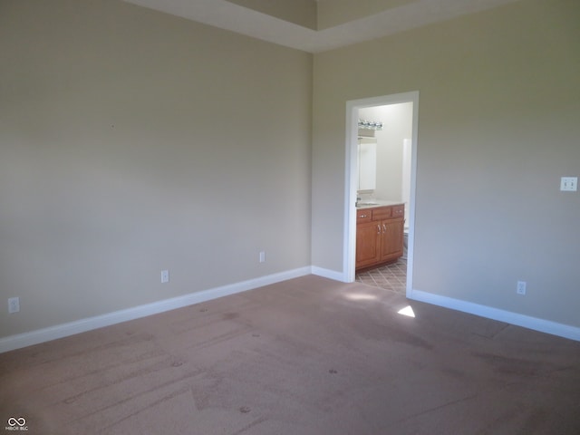 unfurnished room featuring light carpet