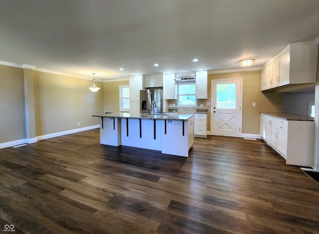 kitchen featuring a kitchen breakfast bar, dark hardwood / wood-style flooring, and white cabinets